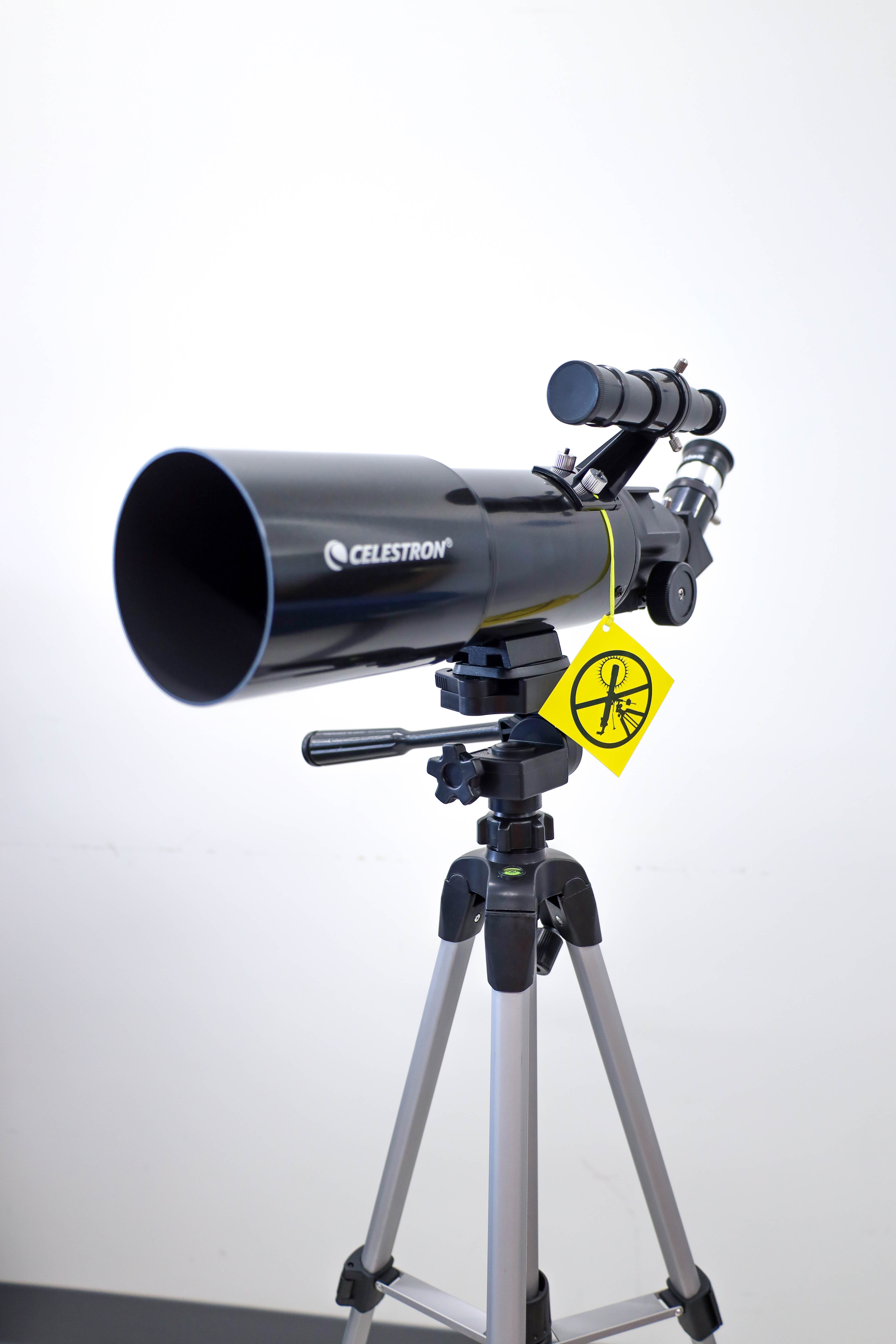 Image of a telescope on a white backdrop