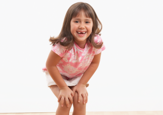 Child with their hands on their knees